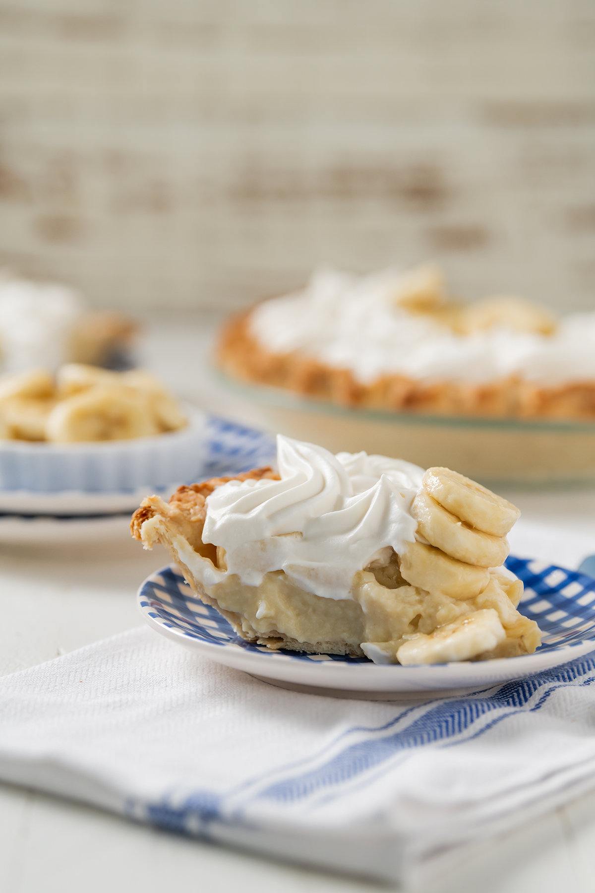 Close up shot of sliced Banana Cream Pie on plate.