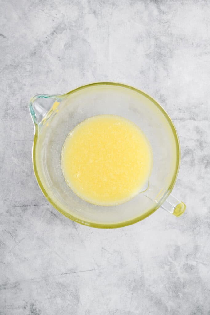 Overhead shot of melted butter, oil and ice cold water combined for Black Forest Cake.