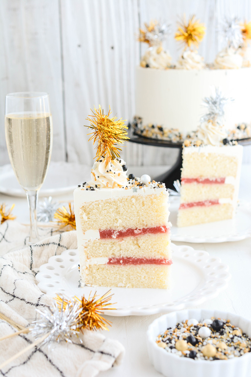 Wide open shot of sliced Champagne Cake with Strawberry Filling cakes on cake plates.