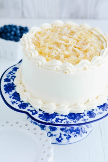 Lemon Blueberry Layer Cake three quarter angle on cake pedestal.