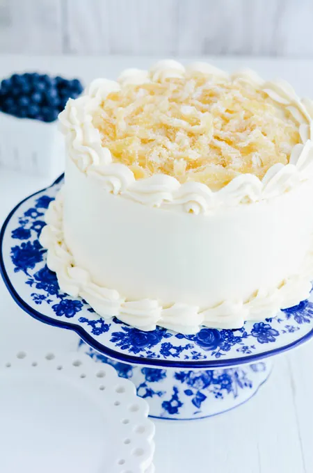 Lemon Blueberry Layer Cake three quarter angle on cake pedestal.