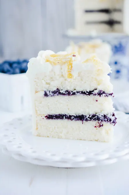 Lemon Blueberry Layer Cake close up shot of cake slice.
