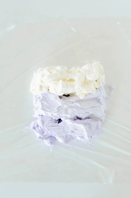 Lavender Lemon Layer Cake overhead shot of colorful buttercream on plastic wrap
