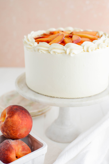Peaches and Cream Layer Cake close up on cake pedestal.