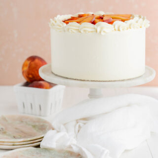 Peaches and Cream Layer Cake wide open shot of cake on pedestal.