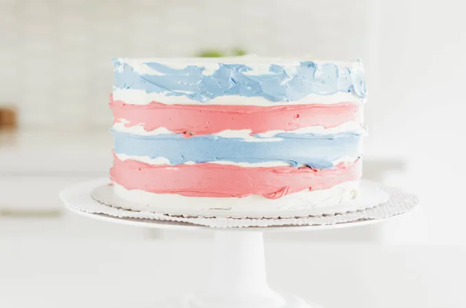 Stars and Stripes Vanilla Cake with colored buttercreams pressed into the cake ridges.