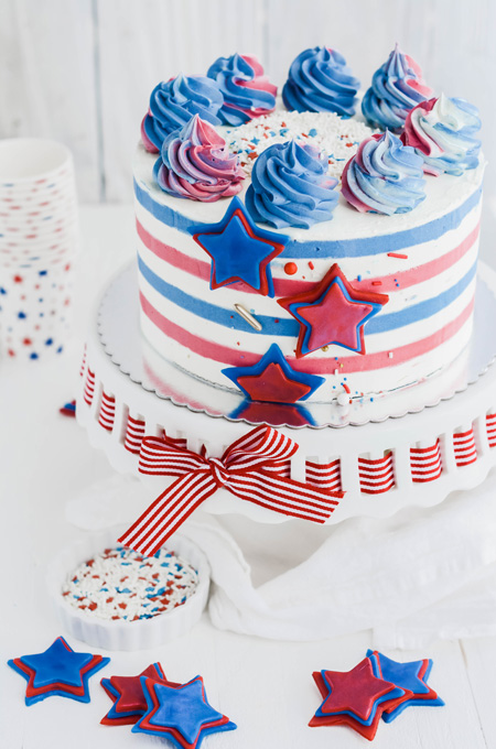 Stars and Stripes Vanilla Cake three quarter angle of cake on pedestal.