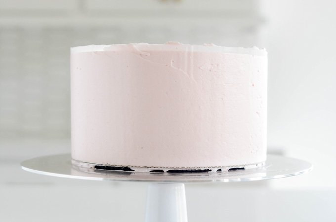 Strawberry Ice Cream Pop Cake smoothed frosting with acrylic disc.