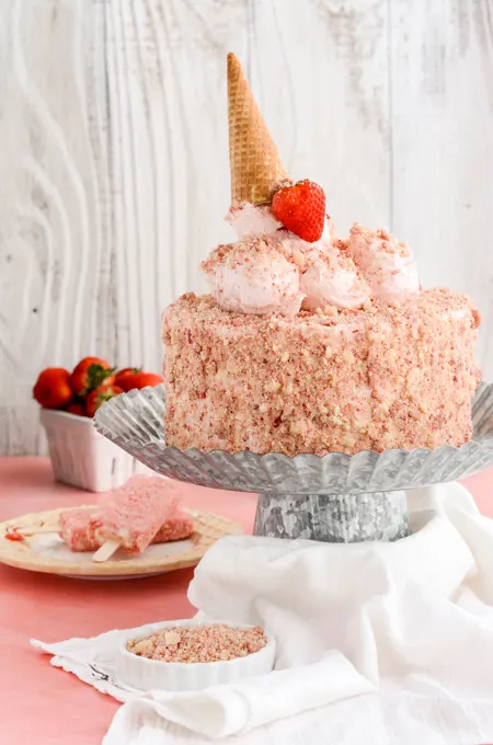 Strawberry Ice Cream Pop Cake wide open shot of cake on pedestal.