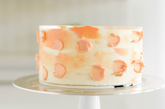 Orange Creamsicle Layer Cake with light orange spots.