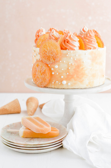 Orange Creamsicle Layer Cake on cake pedestal.