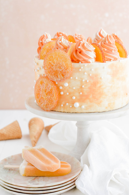 Orange Creamsicle Layer Cake close up shot of cake on pedestal.