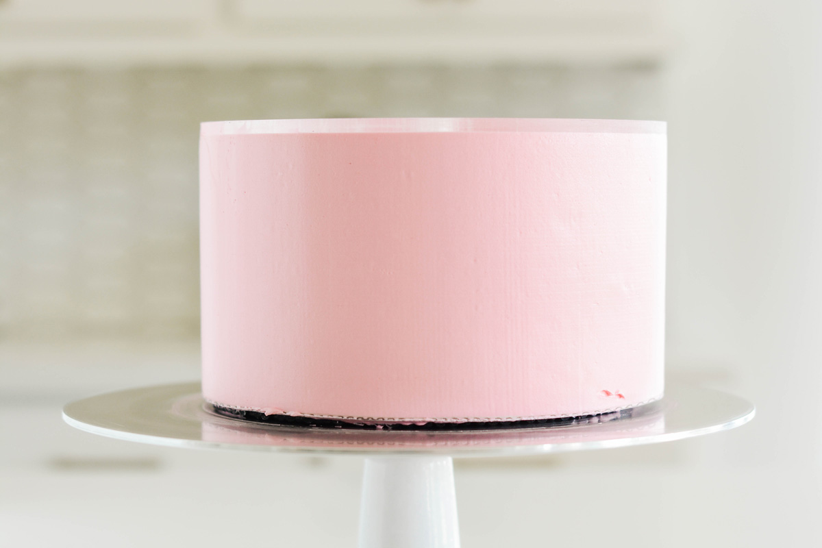Vanilla Birthday Cake with smoothed pink frosting.