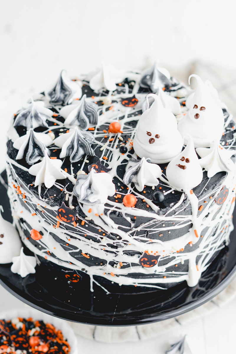 Close up of meringue ghost on top of Black Velvet Halloween Cake