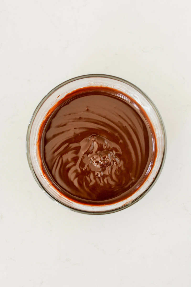 Overhead shot of melted chocolate drip for Devil’s Food Halloween Cake.