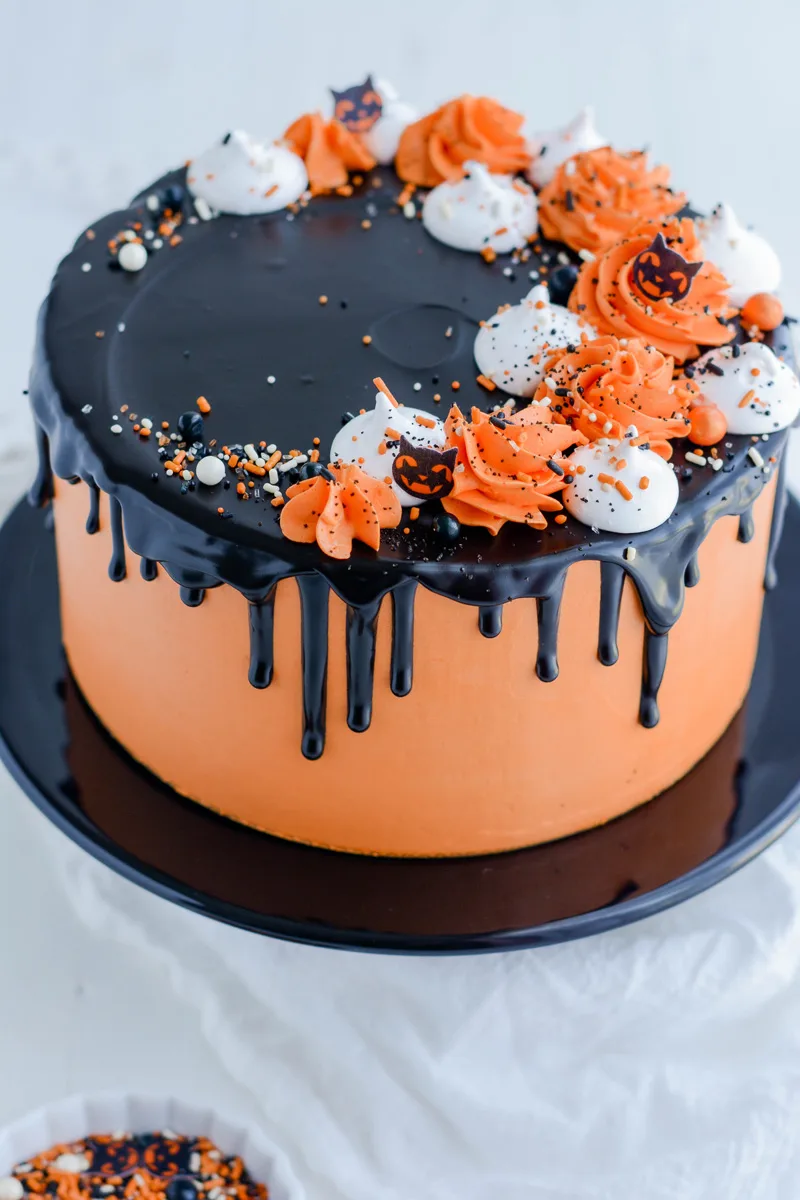 Three quarter angle of cake on black cake pedestal.