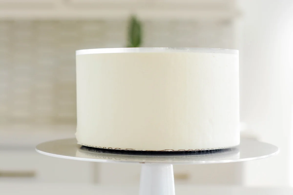 Smoothed frosting with disc attached on Fluffy Red Velvet Cake.