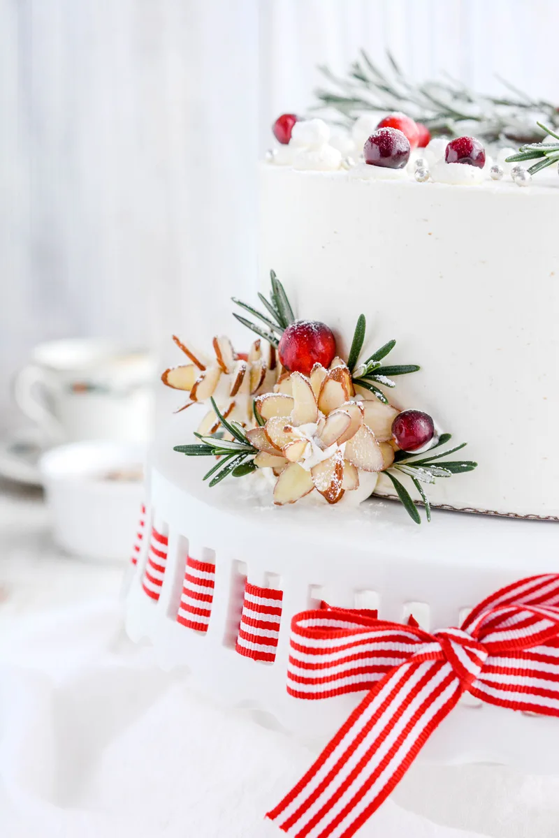 Close up of almond pine cones on the bottom border of Eggnog Layer Cake.