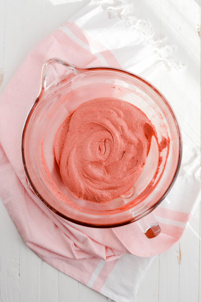 Overhead shot of beaten butter, sugar, oil and emulsion for Valentine's Red Velvet Cake.