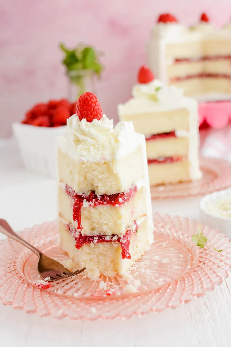 Close up shot of eaten cake slice of White Chocolate Raspberry Cake.