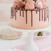 Chocolate Covered Strawberries Cake on marble cake pedestal.