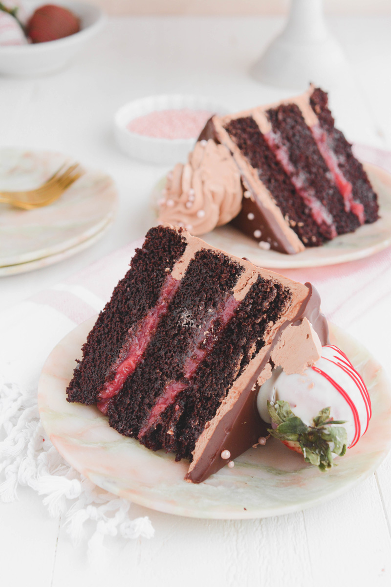 Close up of Chocolate Covered Strawberries Cake sliced on a plate.