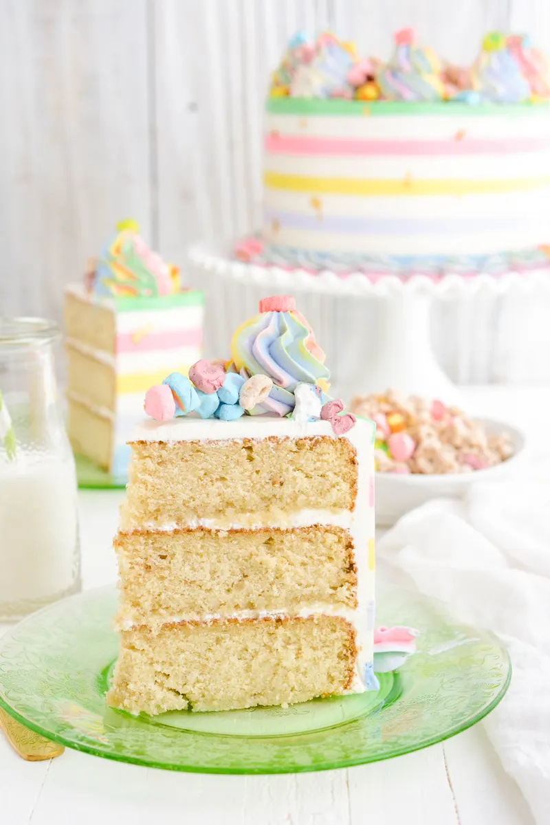 Lucky Charms Layer Cake sliced on a green plate.