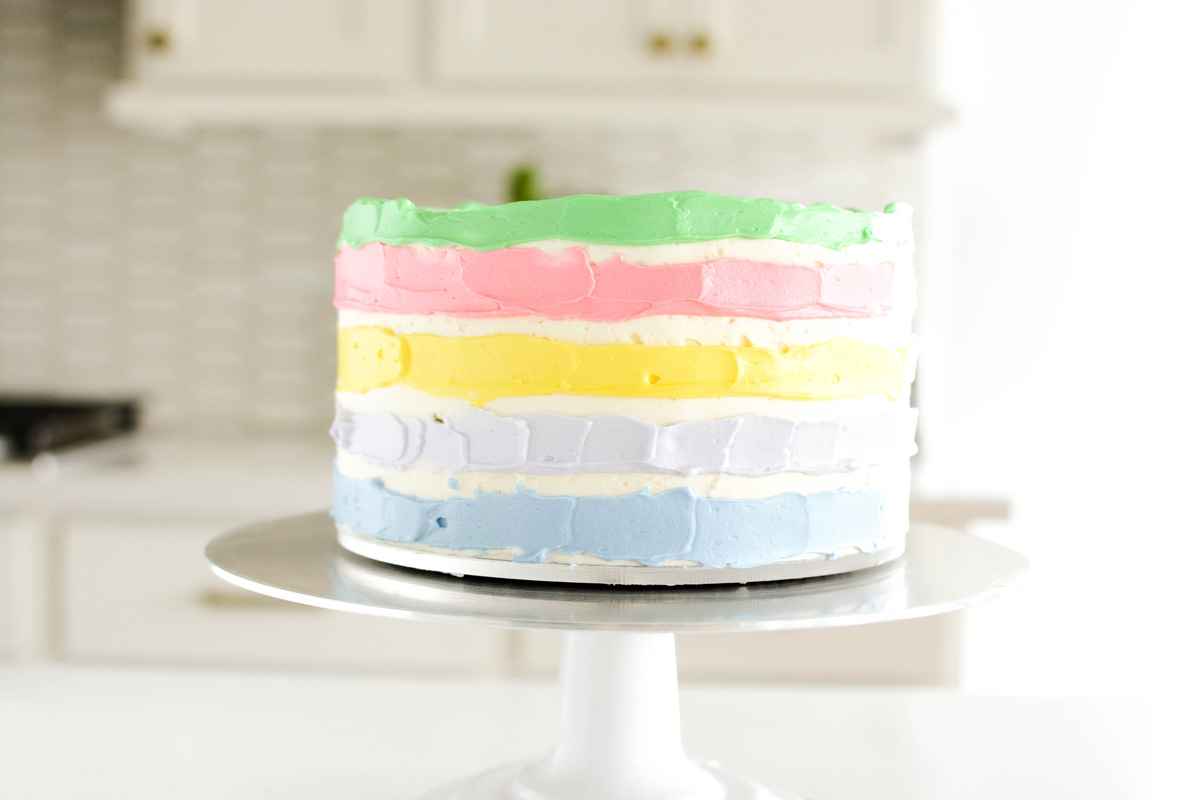 Lucky Charms Layer Cake with colored frosting applied to the rows.