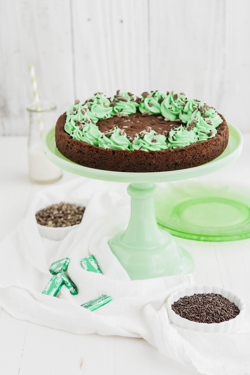 Mint Chocolate Chip Cookie Cake on green cake pedestal.