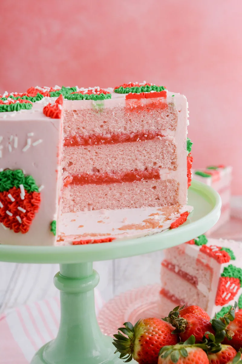 Close up shot of cake layers on pedestal for Strawberry Patch Layer Cake.