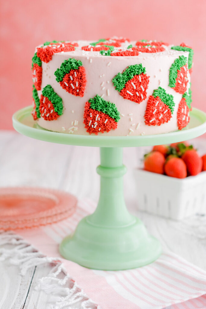 Strawberry Patch Layer Cake on green cake pedestal.
