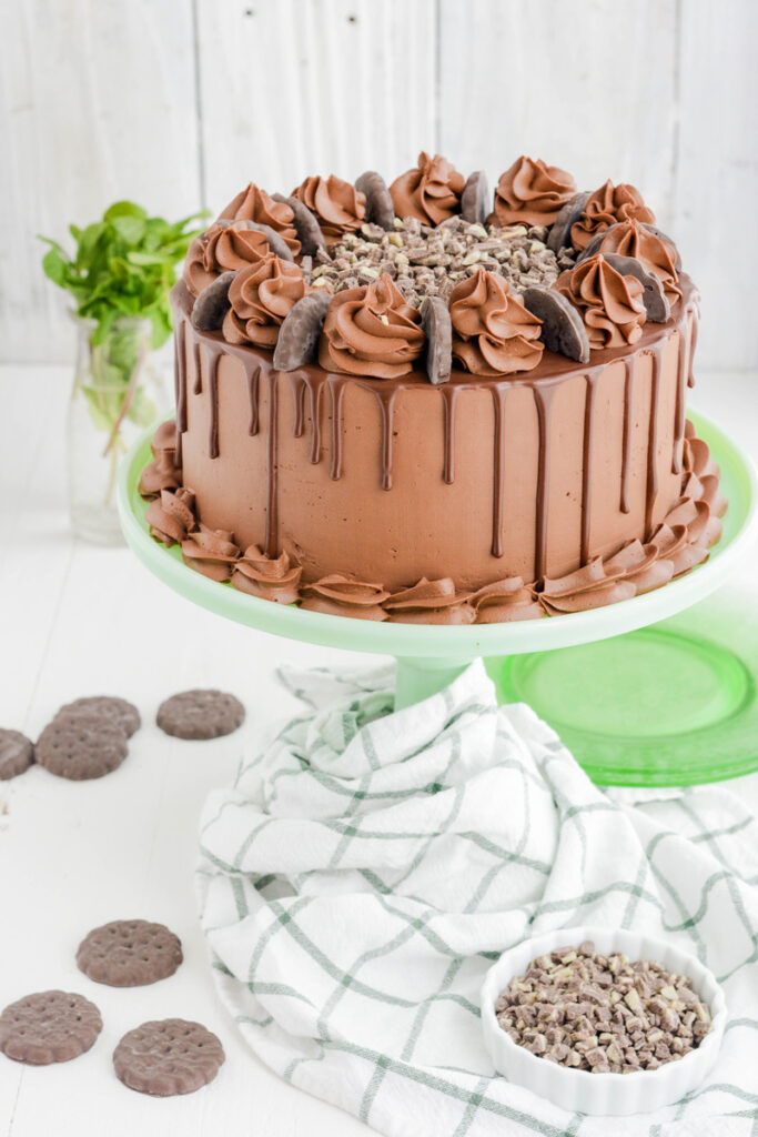 Chocolate Mint Cookie Layer Cake on green cake pedestal.