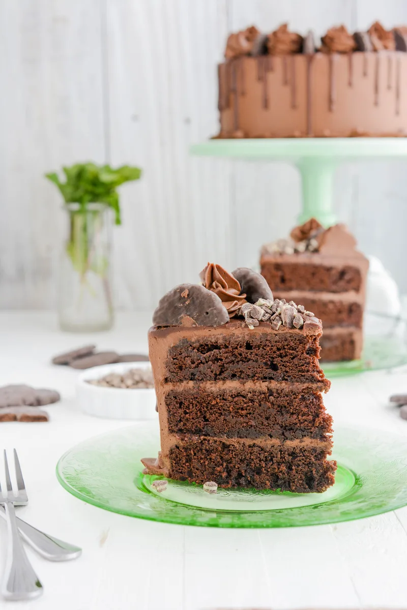 Chocolate Mint Cookie Layer Cake sliced on a green plate.