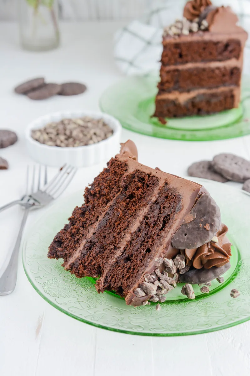 Chocolate Mint Cookie Layer Cake sliced on its side on green plate.