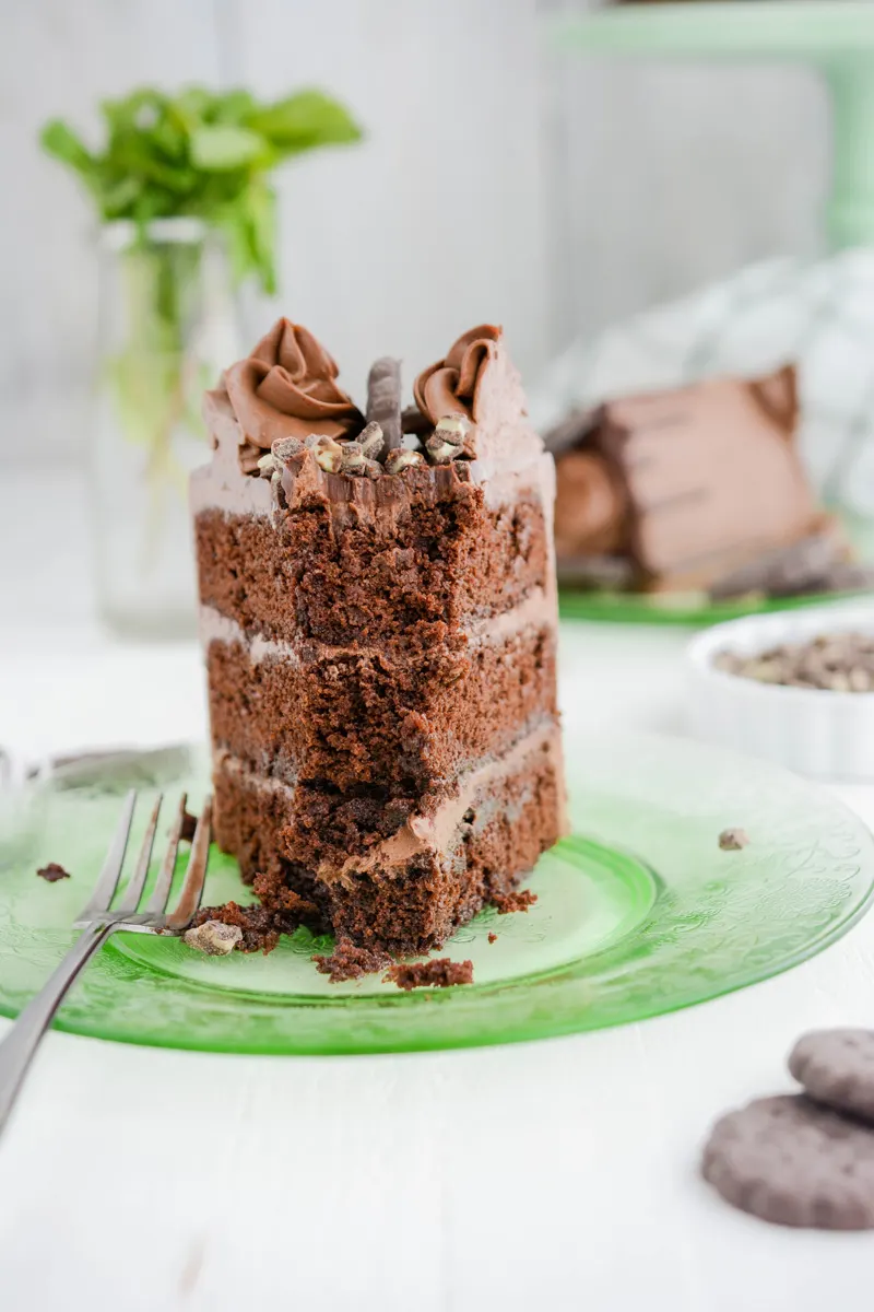 Close up slice of Chocolate Mint Cookie Layer Cake with fork.