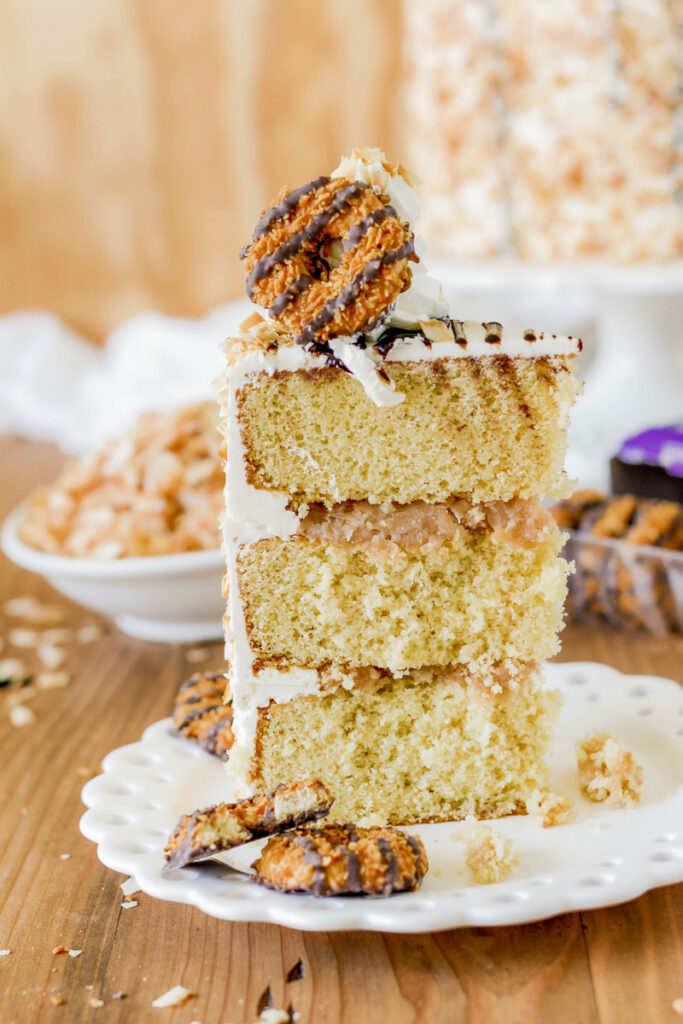 Toasted Coconut Caramel Layer Cake sliced on a plate.
