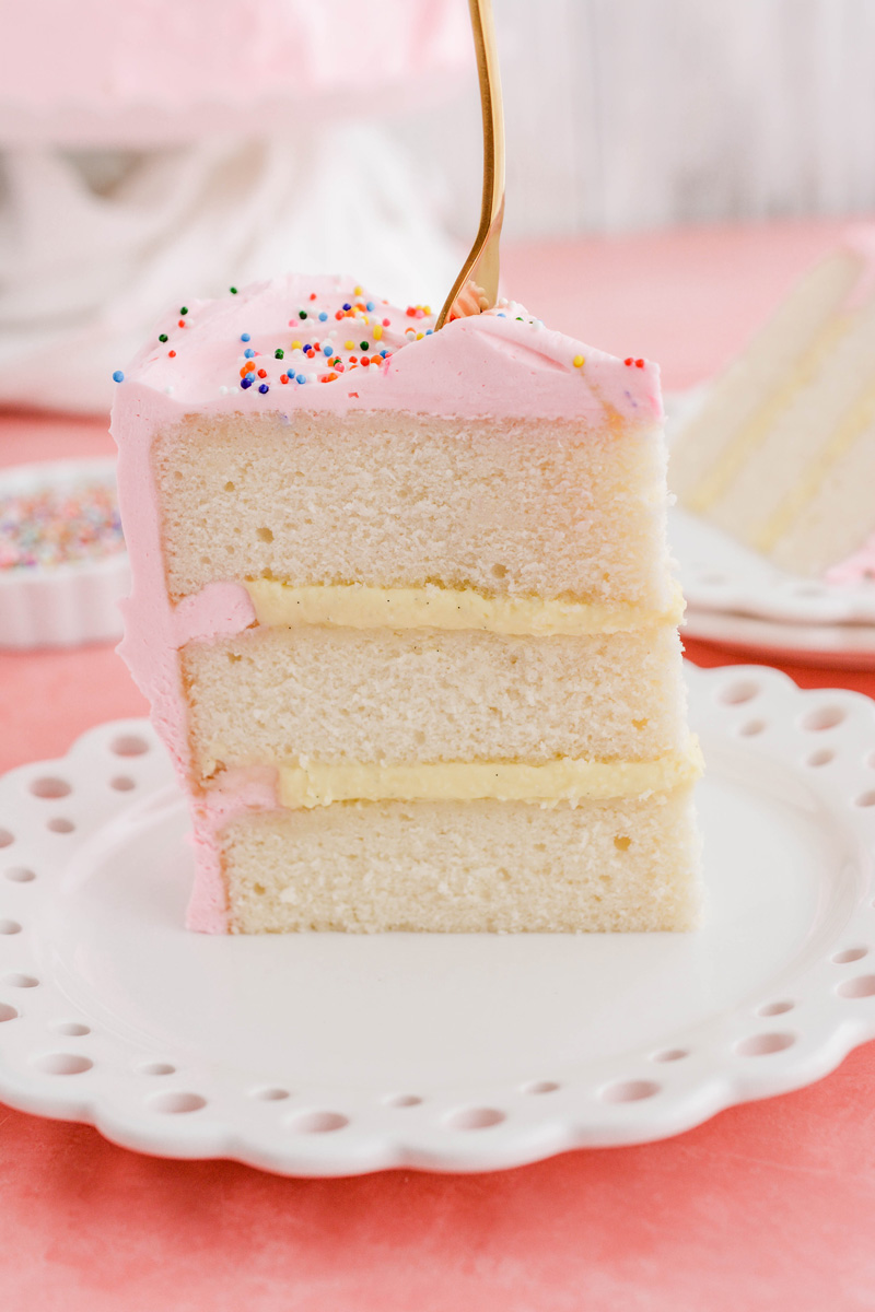 Close up of sliced Mexican Pink Layer Cake with a fork in it.