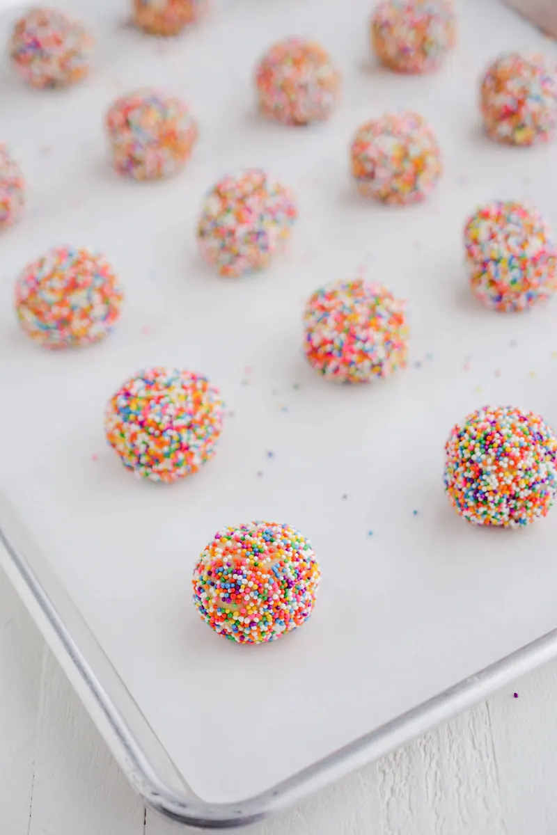Cookie dough balls on prepared baking sheet for Mexican Sprinkle Cookies.