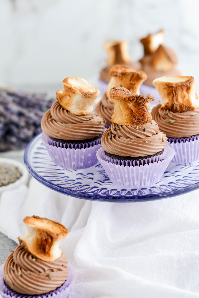 Close up of Hot Chocolate Lavender Cupcakes on lavender cake stand.