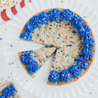 Overhead shot of July 4th Cookie Cake with slice removed on to a plate.