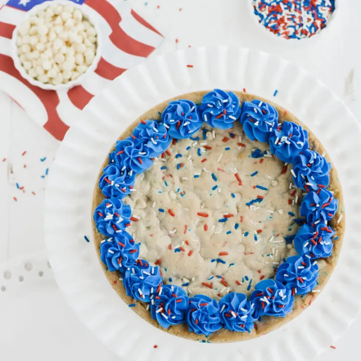 Overhead shot of July 4th Cookie Cake on white cake pedestal.