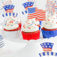 Close up of July 4th Red Velvet Cupcakes on white cake pedestal.