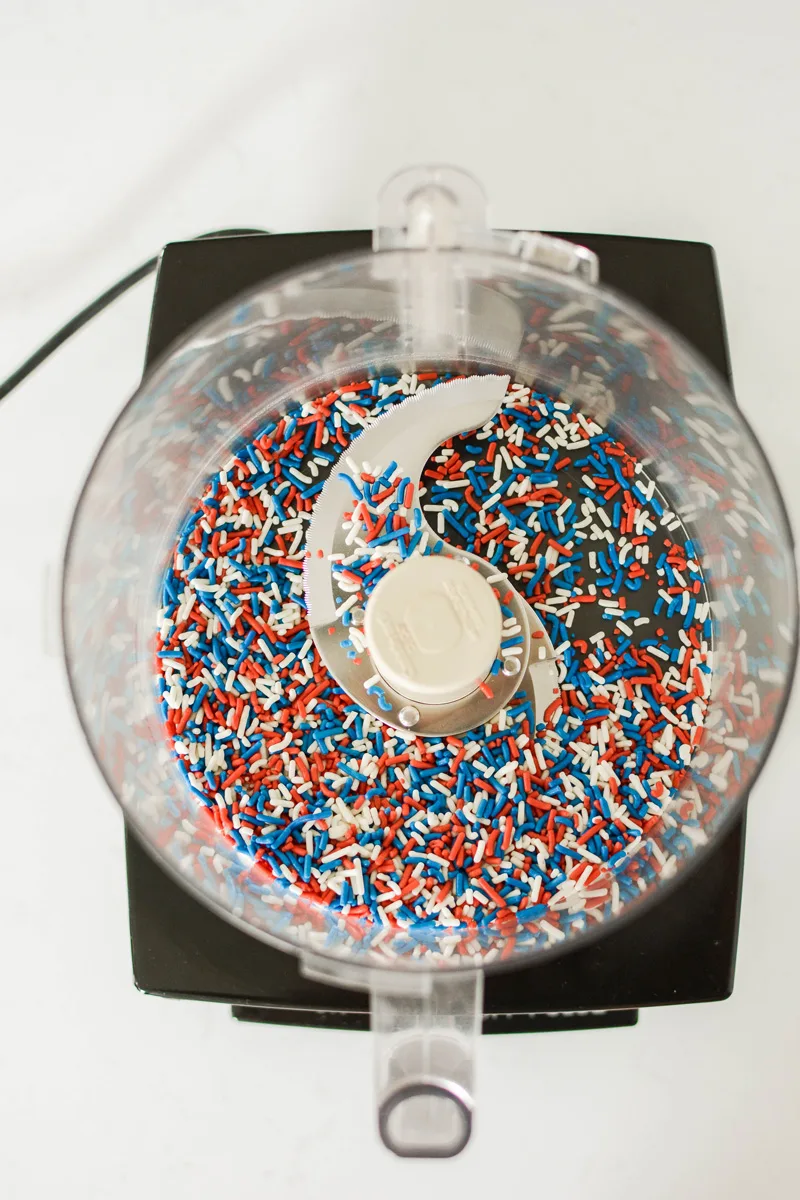 Overhead shot of festive sprinkles in food process for Patriotic Confetti Cake.