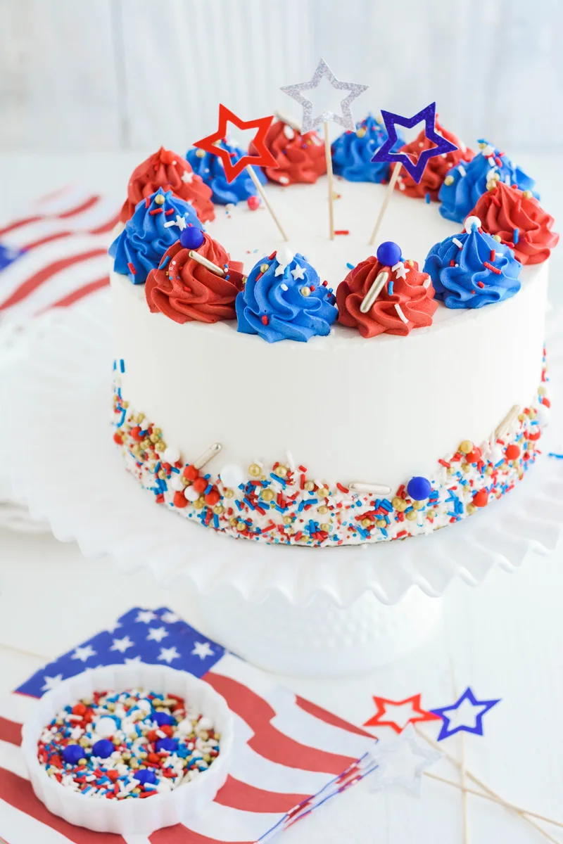 Three quarter angle Patriotic Confetti Cake on cake pedestal.