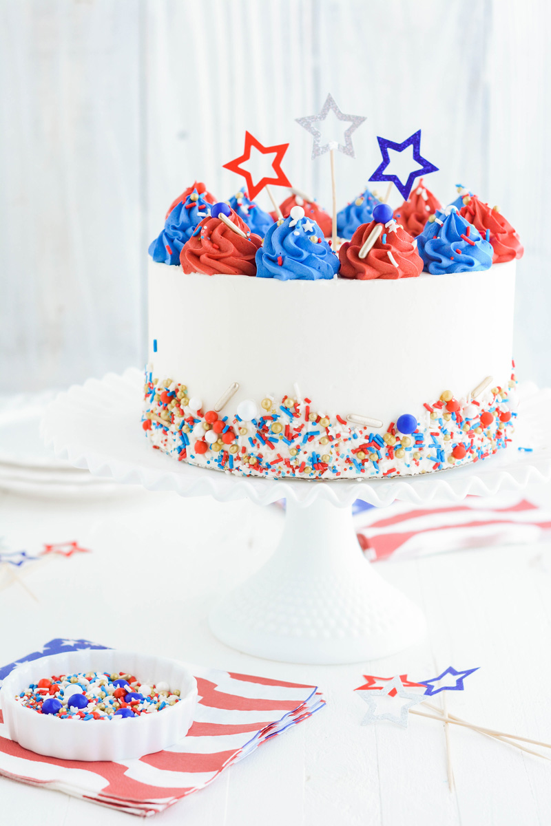 Patriotic Confetti Cake on white cake pedestal.
