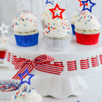 Patriotic Confetti Cupcakes on cake pedestal.