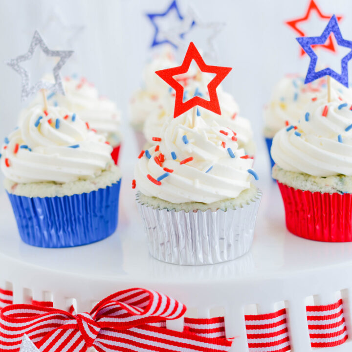 Close up of Patriotic Confetti Cupcakes on white cake stand.
