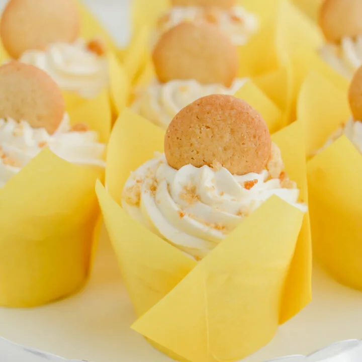 Close up of Banana Cream Pie Cupcakes on white cake pedestal.