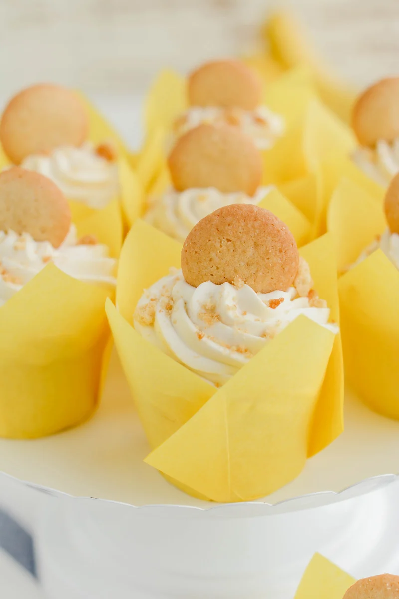 Close up of Banana Cream Pie Cupcakes on white cake pedestal.