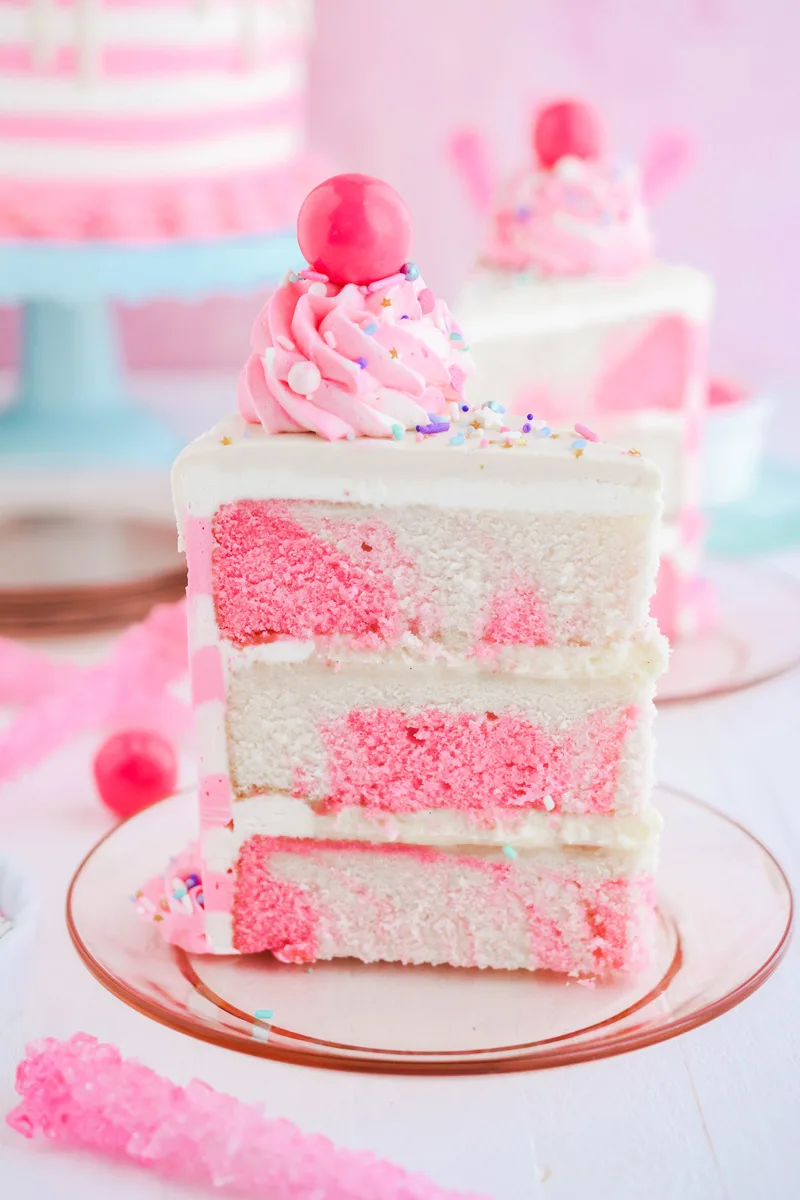 Close up shot of sliced Bubble Gum Layer Cake with vanilla bean filling.